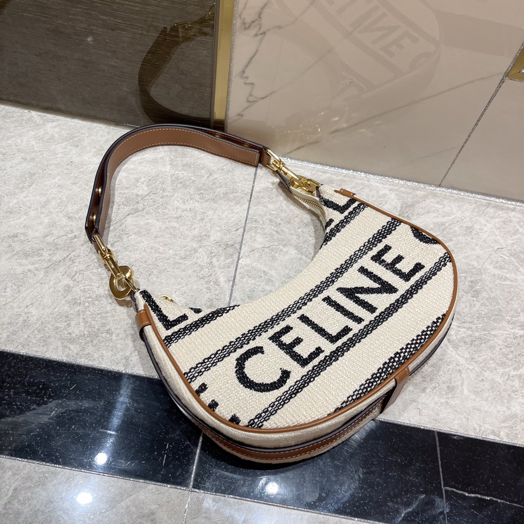 db9bf2_ce51d32e2a56416a80a599dacd7f9513mv2.jpg Celine Linen Crescent Underarm Bag - Image 1