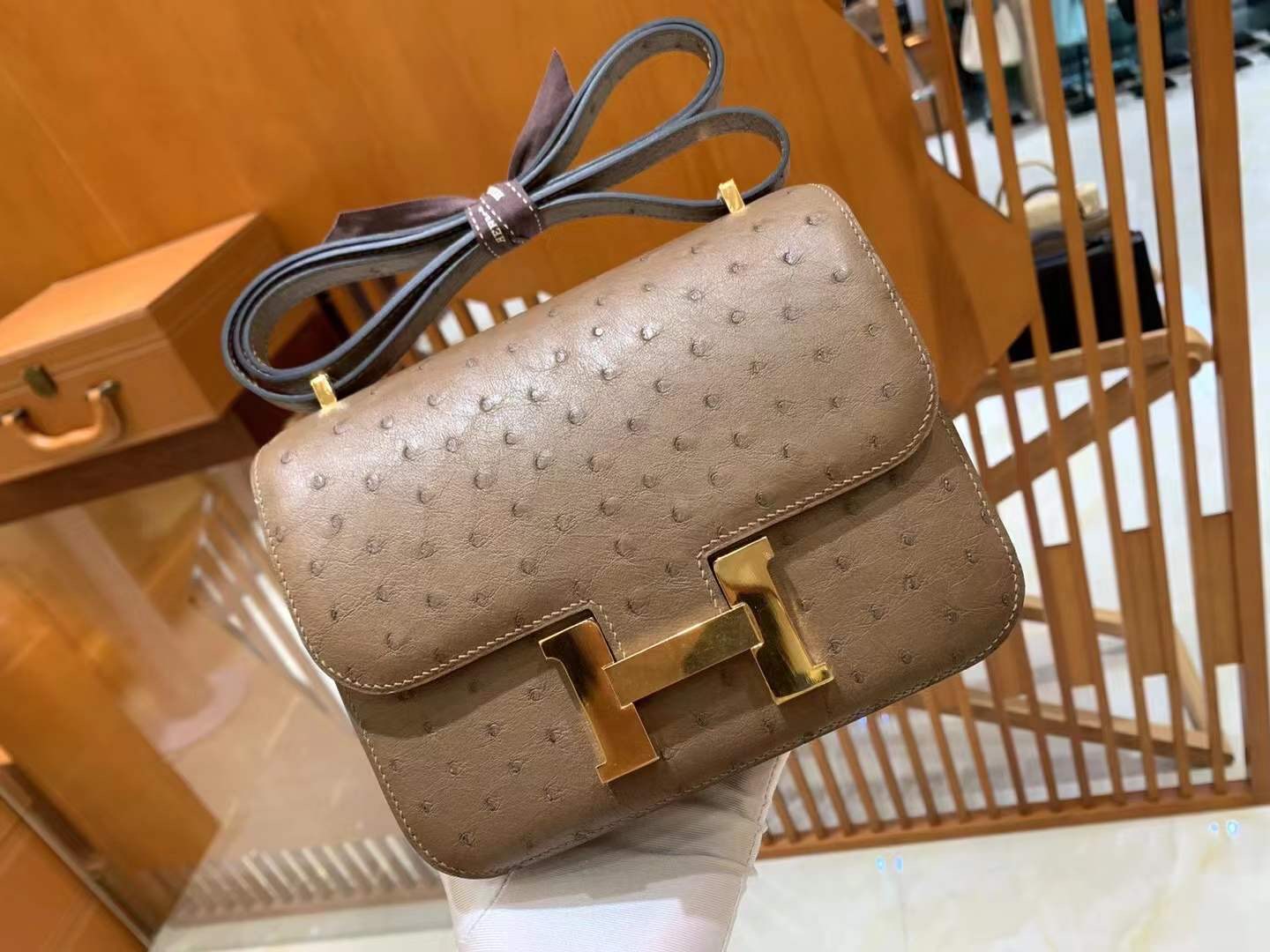 fb638e_3b5f5482be1f4ed6b1594f9a7f220569mv2.jpg Constance 18 Ostrich Brown - Image 1