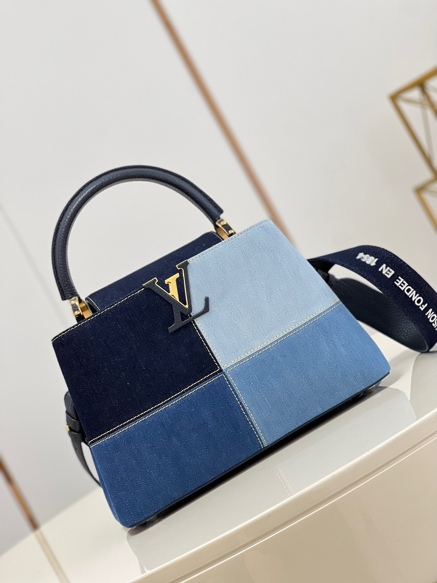 fb638e_607ef4c8a53f4950a80ed96b9b2f7556mv2.jpg Louis Vuitton Capucines MM Medium Handbag in Denim - Image 1