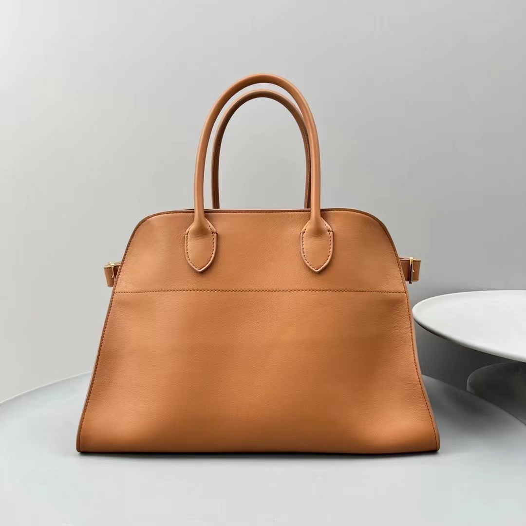 fb638e_cb1f93ab585c4efda67972cbd55f9190mv2.jpg The Row Margaux 17 Tote in Golden Brown Leather - Image 1